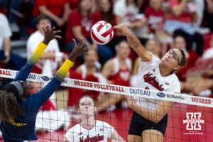 Nebraska Cornhusker Rebekah Allick (5) spikes the ball against Michigan Wolverine middle blocker Serena Nyambio (1) in the first set during a college volleyball match on Wednesday, September 24, 2025, in Lincoln, Nebraska. Photo by John S. Peterson.