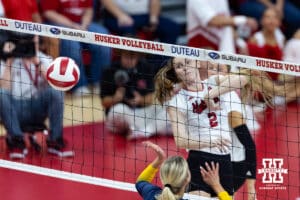 Nebraska Cornhusker Bergen Reilly (2) dunks the ball on Michigan Wolverine middle blocker Jenna Hanes (12) in the first set during a college volleyball match on Wednesday, September 24, 2025, in Lincoln, Nebraska. Photo by John S. Peterson.