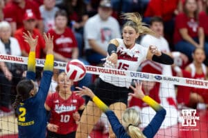 Nebraska Cornhusker Andi Jackson (15) spikes the ball against Michigan Wolverine Allison Jacobs (2) and Allison Jacobs (2) during a college volleyball match on Wednesday, September 24, 2025, in Lincoln, Nebraska. Photo by John S. Peterson.
