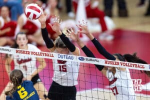 Nebraska Cornhusker Andi Jackson (15) and Harper Murray (27) block the ball against Michigan Wolverine opposite Lydia Johnson (5) in the first set during a college volleyball match on Wednesday, September 24, 2025, in Lincoln, Nebraska. Photo by John S. Peterson.