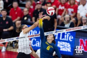 Nebraska Cornhusker Rebekah Allick (5) hits the ball against Michigan Wolverine setter Ellie White (6) in the first set during a college volleyball match on Wednesday, September 24, 2025, in Lincoln, Nebraska. Photo by John S. Peterson.