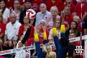 Nebraska Cornhusker Taylor Landfair (12) bumps the ball over Michigan Wolverines in the first set during a college volleyball match on Wednesday, September 24, 2025, in Lincoln, Nebraska. Photo by John S. Peterson.