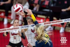 Nebraska Cornhusker Andi Jackson (15) blocks the ball against the Michigan Wolverines in the first set during a college volleyball match on Wednesday, September 24, 2025, in Lincoln, Nebraska. Photo by John S. Peterson.