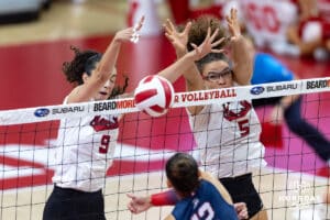 Nebraska Cornhusker Virginia Adriano (9) and Rebekah Allick (5) block a spike from Arizona Wildcat Carlie Cisneros (12) in the second set during a college volleyball match on Saturday, September 20, 2025, in Lincoln, Nebraska. Photo by John S. Peterson.