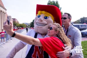 Husker fans take a selfie with Herbie waiting for the Legacy Walk before Nebraska takes on Michigan during a college football game on Saturday, September 20, 2025, in Lincoln, Nebraska. Photo by John S. Peterson.
