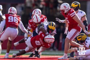 Nebraska Cornhusker Vincent Shavers Jr. (9) tackles Michigan Wolverine Justice Haynes (22) during a college football game on Saturday, September 20, 2025, in Lincoln, Nebraska. Photo by John S. Peterson.