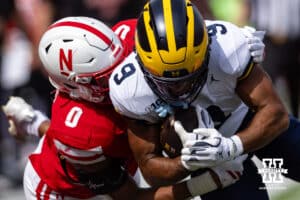 Nebraska Cornhusker Javin Wright (0) tackles Michigan Wolverine Channing Goodwin (9) during a college football game on Saturday, September 20, 2025, in Lincoln, Nebraska. Photo by John S. Peterson.