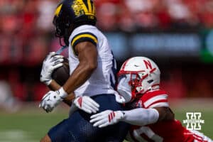Nebraska Cornhusker Andrew Marshall (10) tackles Michigan Wolverine Channing Goodwin (9) in the first quarter during a college football game on Saturday, September 20, 2025, in Lincoln, Nebraska. Photo by John S. Peterson.