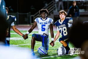 Boys Town's Jayden Cook (5) and Lincoln Lutheran's William Hartung (78) are holding hands in a prayer circle after the game against Lincoln Lutheran on Thursday, September 18, 2025, in Lincoln, Nebraska. Photo By Jack Stephens.