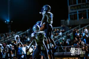Boys Town's Elijah Nhan (4) is celebrating with the team after a big interception during a high school football game against Lincoln Lutheran on Thursday, September 18, 2025, in Lincoln, Nebraska. Photo by Jack Stephens.
