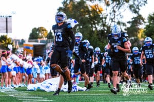 Millard North runs out before the start of the game VS Papio South on Friday, September 12, 2025, in Millard, Nebraska.