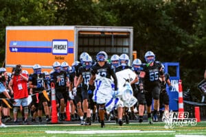 Millard North runs out before the start of the game VS Papio South on Friday, September 12, 2025, in Millard, Nebraska.