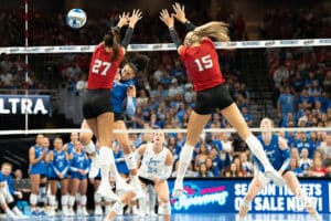 Creighton Bluejay Jaya Johnson splits two defenders for a kill during a volleyball match against Nebraska on Tuesday, September 16th, 2025 in Omaha, Nebraska. Photo by Brandon Tiedemann.