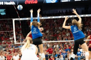 Nebraska Cornhusker Virginia Adriano (9) splits the gap on a kill during a volleyball match against Creighton on Tuesday, September 16th, 2025 in Omaha, Nebraska. Photo by Brandon Tiedemann.