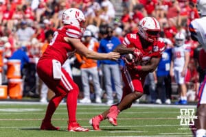 Nebraska Cornhusker Jalyn Gramstad (12) hands the ball off to Trent Uhlir (32) in the fourth quarter against the Houston Christian Huskies during a college football game on Saturday, September 13, 2025, in Lincoln, Nebraska. Photo by John S. Peterson.
