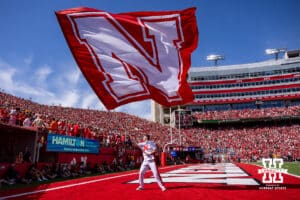 Nebraska Cornhusker cheer squad member waves the flag after a touchdown in the first quarter against the Houston Christian Huskies during a college football game on Saturday, September 13, 2025, in Lincoln, Nebraska. Photo by John S. Peterson.