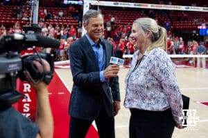 Nebraska Cornhusker former head coach John Cook interviews the current head coach Dani Busboom Kelly after the win over the Grand Canyon Lopes during a college volleyball match on Saturday, September 13, 2025, in Lincoln, Nebraska. Photo by John S. Peterson.