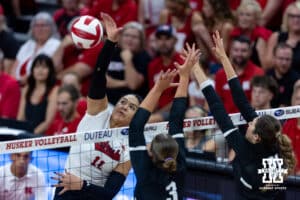 Nebraska Cornhusker Teraya Sigler (11) spikes the ball against Grand Canyon Lope Hayden Goodman (3) and Grand Canyon Lope Bella Nunez (21) during a college volleyball match on Saturday, September 13, 2025, in Lincoln, Nebraska. Photo by John S. Peterson.