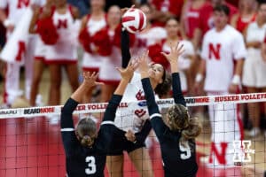 Nebraska Cornhusker Skyler Pierce (21) spikes the ball Grand Canyon Lopes Hayden Goodman (3) and Macey Hughes (9) during a college volleyball match on Saturday, September 13, 2025, in Lincoln, Nebraska. Photo by John S. Peterson.