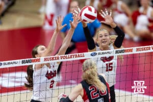 Nebraska Cornhusker Bergen Reilly (2) and Nebraska Cornhusker Andi Jackson (15) blocks the ball against Utah Ute Neea-Maria Joki (20) in the second set during a college volleyball match on Friday, September 12, 2025, in Lincoln, NE. Photo by John S. Peterson.