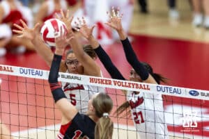 Nebraska Cornhusker Rebekah Allick (5) and Harper Murray (27) blocks a shot from Utah Ute Allie Grossenbach (17) during a college volleyball match on Friday, September 12, 2025, in Lincoln, NE. Photo by John S. Peterson.