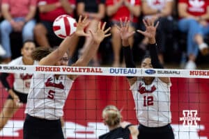 Nebraska Cornhuskers Rebekah Allick (5) and Taylor Landfair (12) block the ball against the Utah Utes in the first set during a college volleyball match on Friday, September 12, 2025, in Lincoln, NE. Photo by John S. Peterson.