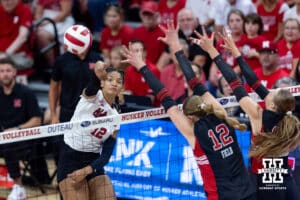 Nebraska Cornhusker Taylor Landfair (12) spikes the ball against the Utah Utes in the first set during a college volleyball match on Friday, September 12, 2025, in Lincoln, NE. Photo by John S. Peterson.