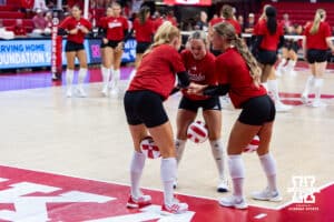 Nebraska Cornhuskers Olivia Mauch (10), Laney Choboy (6), and Maisie Boesiger (7) huddle up before warm-up during a college volleyball match against the Utah Utes on Friday, September 12, 2025, in Lincoln, NE. Photo by John S. Peterson.