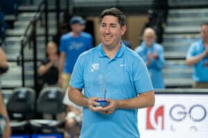 Creighton volleyball head coach Brian Rosen is gifted an award for his first win as Creighton head coach before a volleyball match against Louisville on Friday, September 12th, 2025 in Omaha, Nebraska. Photo by Brandon Tiedemann.