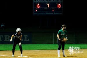 The Marian runner and Skutt 3rd baseman are on their toes in the late game shown behind them during the Skutt vs Marian Softball game on September 4th, 2025 in Omaha, Nebraska. Photo by Drew Balus
