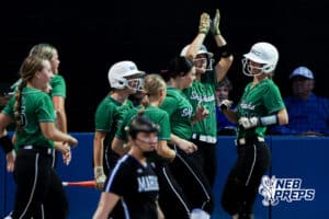 The team celebrates with high-fives after a late homerun during the Skutt vs Marian Softball game on September 4th, 2025 in Omaha, Nebraska. Photo by Drew Balus