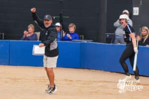 The Marian 3rd base coach gets hyped on the big hit during the Skutt vs Marian Softball game on September 4th, 2025 in Omaha, Nebraska. Photo by Drew Balus