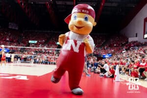 Nebraska mascot Lil' Red dancing around at a break in the action against the California Golden Bears during a college volleyball match on Sunday, September 7, 2025 in Lincoln, NE. Photo by John S. Peterson.