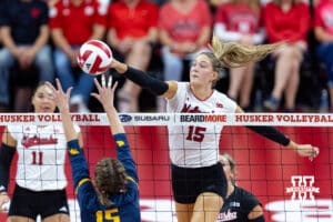 Nebraska Cornhusker Andi Jackson (15) spikes the ball against California Golden Bear Arissa Carbonara (17) in the second set during a college volleyball match on Sunday, September 7, 2025 in Lincoln, NE. Photo by John S. Peterson.