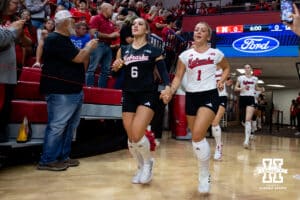 Nebraska Cornhusker Laney Choboy (6) and Keri Leimbach (1) run out to take on California Golden Golden Bears during a college volleyball match on Sunday, September 7, 2025 in Lincoln, NE. Photo by John S. Peterson.