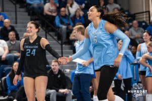 Creighton Bluejays Sydney Breissinger #24 and Jaya Johnson #6 laugh together during a volleyball match against DePaul on Friday, October 31, 2025, in Omaha, Nebraska. Photo by Brandon Tiedemann.