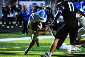 Benningtons Will Gutz (20) is stumbling into the end zone for a rushing touchdown during a high school football game against Elkhorn North on Thursday, October 23, 2025 in Omaha, Nebraska. Photo By Jack Stephens.