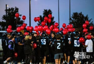 Elkhorn North Seniors with their parents during pregame before a high school football game against Bennington on Thursday, October 23, 2025 in Omaha, Nebraska. Photo By Jack Stephens.