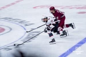 Omaha Maverick Marcus Nguyen goes after the puck against the UMass Minutemen during a hockey match at Baxter Arena on October 24th, 2025, in Omaha, Nebraska. Photo by Collin Stilen.