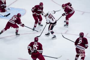 Omaha Maverick Brett Hyland gets surrounded by five players from UMass during a hockey match at Baxter Arena on October 24th, 2025, in Omaha, Nebraska. Photo by Collin Stilen.