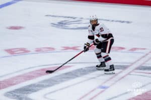 Omaha Maverick Jacob Guevin with Baxter words behind during a hockey match at Baxter Arena against the UMass Minutemen on October 24th, 2025, in Omaha, Nebraska. Photo by Collin Stilen.