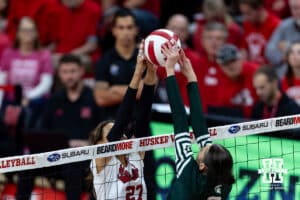 Nebraska Cornhusker outside hitter Harper Murray (27) and Michigan State Spartan outside hitter Bianca Mumcular (3) battle at the net in the third set during a college volleyball match on Saturday, October 25, 2025, in Lincoln, Nebraska. Photo by John S. Peterson.