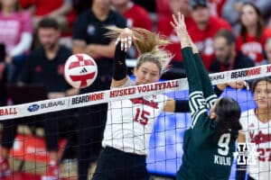 Nebraska Cornhusker middle blocker Andi Jackson (15) spikes the ball passed Michigan State Spartan middle blocker Zuzanna Kulig (9) in the third set during a college volleyball match on Saturday, October 25, 2025, in Lincoln, Nebraska. Photo by John S. Peterson.