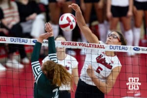 Nebraska Cornhusker middle blocker Rebekah Allick (5) spikes the ball against Michigan State Spartan setter Malayah Long (7) in the second set during a college volleyball match on Saturday, October 25, 2025, in Lincoln, Nebraska. Photo by John S. Peterson.