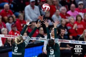 Nebraska Cornhusker outside hitter Teraya Sigler (11) spikes the ball against Michigan State Spartan outside hitter Karolina Staniszewska (2) and middle blocker Zuzanna Kulig (9) in the second set during a college volleyball match on Saturday, October 25, 2025, in Lincoln, Nebraska. Photo by John S. Peterson.