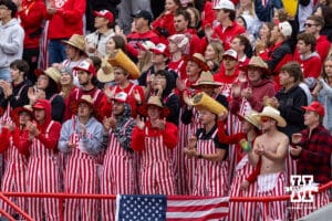 Nebraska Cornhusker students wearing striped coveralls during a college football game against the Northwestern Wildcats on Saturday, October 25, 2025, in Lincoln, Nebraska. Photo by John S. Peterson.