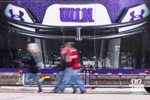 Nebraska Cornhusker fans walking by the Northwestern Wildcats equipment truck during a college football game on Saturday, October 25, 2025, in Lincoln, Nebraska. Photo by John S. Peterson.