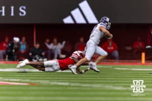 Nebraska Cornhusker wide receiver Jacory Barney Jr. (2) tackles Northwestern Wildcat linebacker Mac Uihlein (37) after he intercepted a pass in the fourt quarter during a college football game on Saturday, October 25, 2025, in Lincoln, Nebraska. Photo by John S. Peterson.