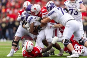 Nebraska Cornhusker defensive lineman Keona Davis (97) tackles Northwestern Wildcat running back Caleb Komolafe (5) in the third quarter during a college football game on Saturday, October 25, 2025, in Lincoln, Nebraska. Photo by John S. Peterson.