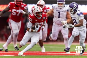 Nebraska Cornhusker running back Isaiah Mozee (22) runs with the football against Northwestern Wildcat defensive back Braden Turner (9) for a first down in the second quarter during a college football game on Saturday, October 25, 2025, in Lincoln, Nebraska. Photo by John S. Peterson.